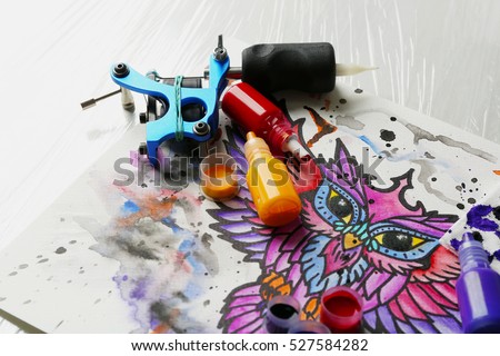 tattoo machine sketch supplies on table stock photo 527584312 tattoo machine sketch supplies on table stock photo 527584312