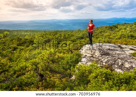 https://thumb9.shutterstock.com/display_pic_with_logo/1391644/703956976/stock-photo-woman-stands-on-a-cliff-edge-and-enjoys-the-nature-at-high-point-on-top-of-shawangunk-ridge-in-703956976.jpg