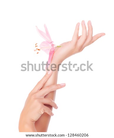 Photo of beautiful female hands with pink lily flower, women's body part isolated on white background, dayspa, natural cosmetics for arms, luxury beauty and spa salon, manicure and massage concept