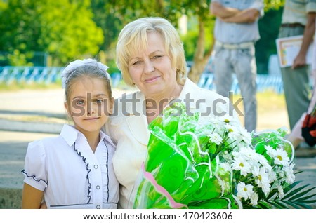 Teacher and pupil. girl gives flowers a school teacher in teacher's day