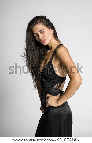 https://thumb9.shutterstock.com/display_pic_with_logo/1431185/691072186/stock-photo-young-beautiful-woman-in-fancy-black-dress-691072186.jpg