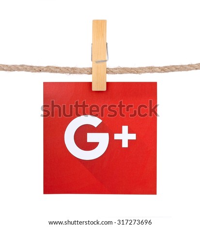 KIEV, UKRAINE - SEPTEMBER 16, 2015: Popular social media Google plus hanging on the clothesline isolated on white background.Google plus which provides the ability to communicate via the Internet.