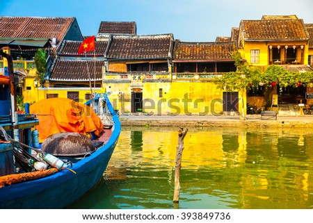 Traditional boats in front of ancient architecture in Hoi An, Vietnam. Hoi An is the World's Cultural heritage site, famous for mixed cultures & architecture.