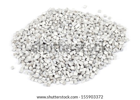 grey plastic polymer granules on white background