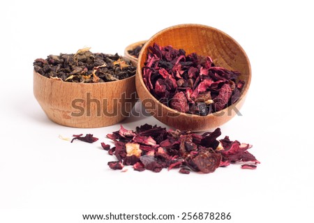 Dry tea in wooden plates, on white background. Leaves of red, green and black tea. Macro photo.