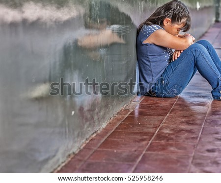 Asian girl sad at school. Isolation and bullying concept.