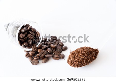 Spilled Coffee Beans From Transparent Cup Powder On Spoon Isolated White Background Spilled Coffee Beans From Transparent Cup Powder On Spoon Isolated White Background