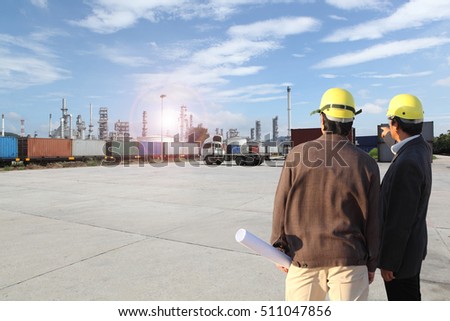 two businessman or engineering man working at Chemical Industry, Storage Tank And Tanker Truck In Industrial Plant