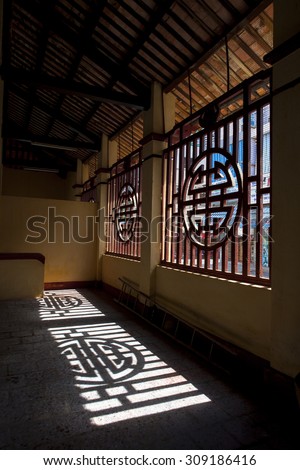 TIEN GIANG, VIETNAM, MAY 26, 2013. A view of window shadow in a temple on early morning. GO CONG, TIEN GIANG, VIETNAM, MAY 26, 2013