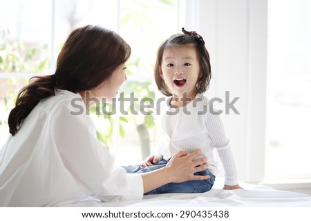 Upskirt sneak peeks Asian mother and daughter kissing