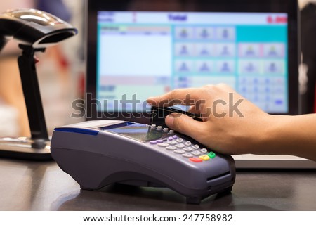 Hand Swiping Credit Card In Store