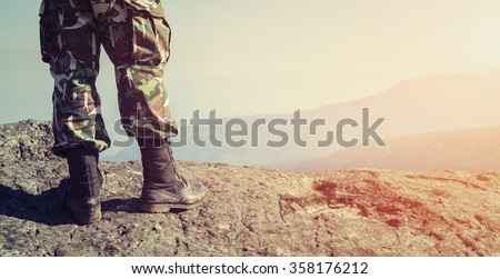 Soldier on the top of a mountain