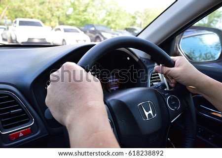 Bangkok, Thailand - April 10, 2017: Honda Black Steering Wheel And Silver Logo. Honda Motor Co., Ltd. is a Japanese public multinational conglomerate corporation. Man driving car.