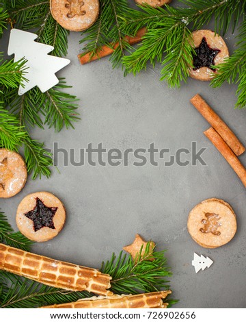 Ginger homemade cookies with strawberry jam on gray concrete background with Christmas tree. View with copy space. Flat lay, top view. Christmas Border -banner.