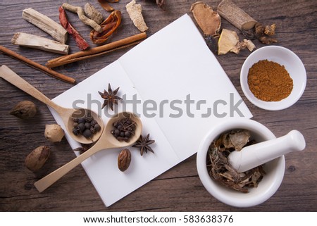 Herbal medical with white mortar and notebook, education concept.