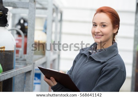 mechanical engineer taking notes at metallurgy factory