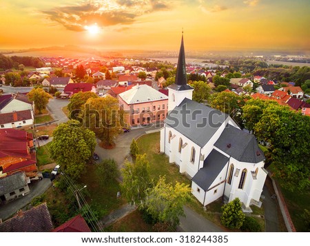 Beautiful sunset over gothic church St. Peter and Paul in The Litice suburb of Pilsen. Aerial view to romantic citiscape in Czech Republic, Central Europe. HDR (warm filtered) photography. 