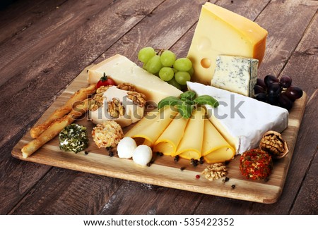 Cheese platter with different cheese and grapes