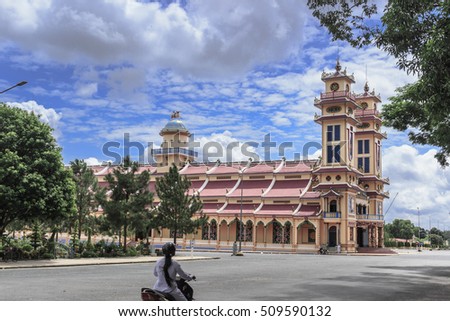TAY NINH, VIETNAM - October 23, 2016:Cao Dai temple area and meditating followers of the Cao Dai religion in the temple Cao Dai