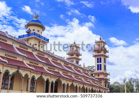 TAY NINH, VIETNAM - October 23, 2016:Cao Dai temple area and meditating followers of the Cao Dai religion in the temple Cao Dai