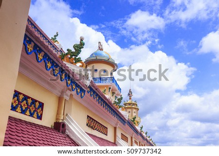 TAY NINH, VIETNAM - October 23, 2016:Cao Dai temple and meditating followers of the Cao Dai religion in the temple Cao Dai