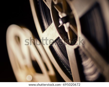 film projector on a black background with dramatic lighting and selective focus