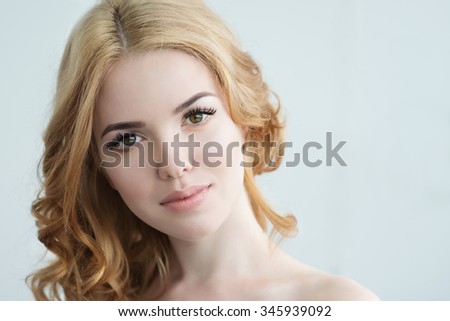 Beauty Model with Perfect Fresh Skin and Long Eyelashes. Youth and Skin Care Concept. Spa and Wellness. Make up and Hair. Lashes. Close up, selected focus.