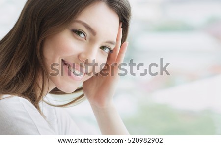 Beauty smiling model with natural make up and long eyelashes. Youth and skin care concept. Spa and wellness. Make up, long hair and lashes. Close up, selective focus.