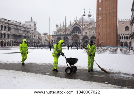 Venice, Italy - March 1, 2018: Venice in snow, workers are cleaning snow on St. Mark square, snowing in Venice, Italy, march 2018