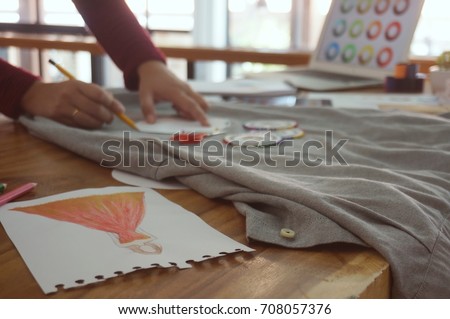 Stylish Fashion Designer work as sketch of new collection in atelier. Creative Design Concept.