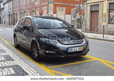 Porto, Portugal - February, 26, 2017: Honda Insight hybrid car parking on the street.