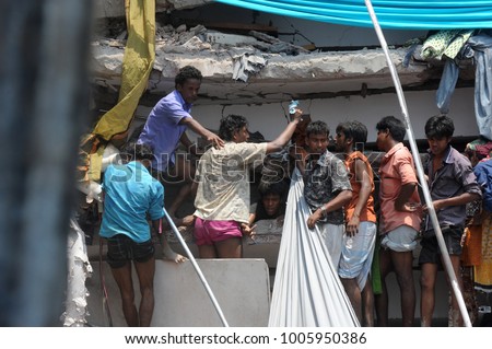 DHAKA, BANGLADESH - APRIL 24, 2013: Rescue workers try rescue trapped garment workers in the Rana plaza building which collapsed in Saver near Dhaka, Bangladesh on April 24, 2013.