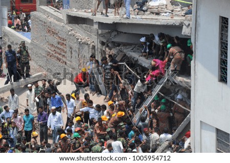 DHAKA, BANGLADESH - APRIL 24, 2013: Rescue workers try rescue trapped garment workers in the Rana plaza building which collapsed in Saver near Dhaka, Bangladesh on April 24, 2013.