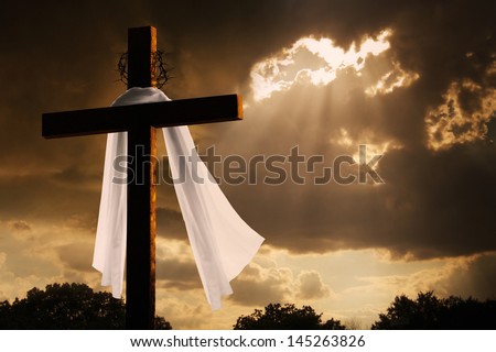 This dramatic lighting with storm clouds breaking and sunshine bursting through makes a great Easter photo illustration of Jesus dying on the cross and rising again. - stock photo