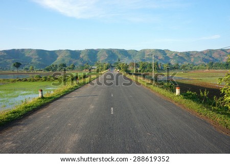 Beautiful Vietnamese countryside landscape, way forward chain of mountain in morning, field along highway, fresh environment, eco green, street like goal or target