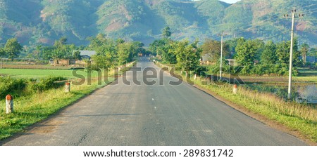 Beautiful Vietnamese countryside landscape, way forward chain of mountain in morning, field along highway, fresh environment, eco green, street like goal or target