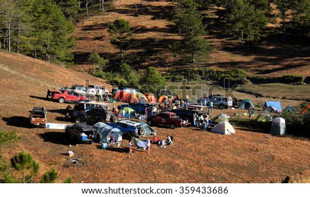 DA LAT, VIET NAM- JAN 2: Group of person in family vacation in spring, people with 4x4 terrain car camp at pine forest, exciting experience in eco travel with tent, Dalat, Vietnam, Jan 2, 2016