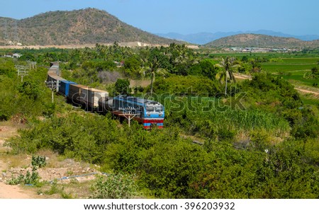 Train moving on rail to transport passenger and good cross Binh Thuan, Viet Nam, green landscape at Binhthuan, Vietnam rural on day rural on day