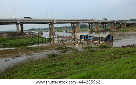 DONG NAI, VIET NAM- JUNE 5: Group of floating house on La Nga fishing village, river with green grass and hyacinth, residence of people who live with fish farming at Dongnai, Vietnam