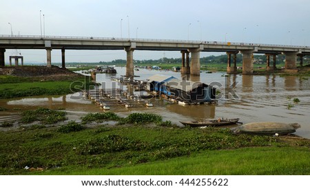 DONG NAI, VIET NAM- JUNE 5: Group of floating house on La Nga fishing village, river with green grass and hyacinth, residence of people who live with fish farming at Dongnai, Vietnam