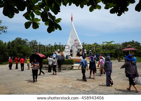 CA MAU, VIET NAM- JULY 16, 2016: Group of tourist travelling Dat Mui, a geography place people walking on breakwater along the beach