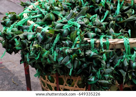 Vietnamese traditional food for may 5th, is double five festival or tet doan ngo, group of sticky rice cake in green leaf, also call banh u tro with pyramidal shape at open air market