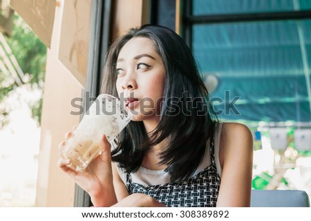 Asian Woman Is Drinking Iced Coffee Asian Woman Is Drinking Iced Coffee