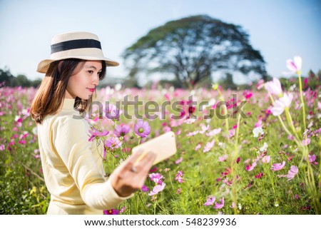 https://thumb9.shutterstock.com/display_pic_with_logo/1771481/548239936/stock-photo-asian-girl-playing-phone-cosmos-flower-garden-548239936.jpg