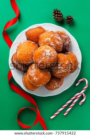 donuts filled with jam, marmalade or cream on a plate . festive New Year or Christmas style