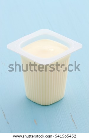 Delicious, nutritious and healthy fresh plain yogurt cup. On vintage retro styling.