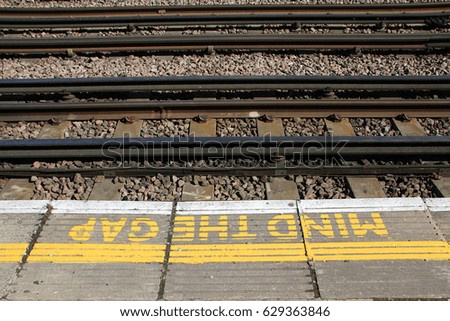 LONDON, ENGLAND - 20 APRIL 2017: A sign painted on a platform on the London Underground warns commuters to MIND THE GAP. The phrase was first introduced in 1969 on the London Underground. Editorial.