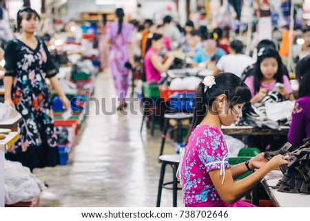 KANCHANABURI, THAILAND - JULY 22, 2017: Burmese Female Migrant Workers Sewing or Stitching Leather Shoes in footwear production line of factory in Sankhlaburi, Kanchanaburi, Thai-Burma border province