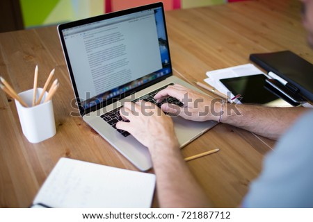 Man business planning expert working on laptop computer. Male content writer for financial presentation using modern notebook. Hipster guy skilled e-book writer using net-book, sitting at desktop
