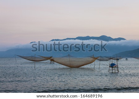 CIRCA APRIL 2010 - QUY NHON, VIETNAM - Fishing nets standing at rest off the shore, on 25 April 2010, at Quy Nhon, Vietnam.
